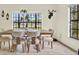 Bright dining room featuring an ample table with seating and a large window view at 11419 Donneymoor Dr, Riverview, FL 33569