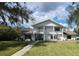 Beautiful two-story white home with large front yard, mature trees, and manicured landscaping at 11419 Donneymoor Dr, Riverview, FL 33569