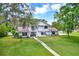 Classic two-story home with a spacious front lawn and inviting porch at 11419 Donneymoor Dr, Riverview, FL 33569