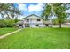 Inviting two-story home boasting lush green lawn, balcony, and charming curb appeal at 11419 Donneymoor Dr, Riverview, FL 33569