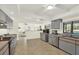 Well-lit kitchen with gray cabinetry, tile flooring, and view of the adjacent living space at 11419 Donneymoor Dr, Riverview, FL 33569
