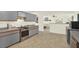 Kitchen boasts stainless steel appliances, tile flooring, and an open layout to the living area at 11419 Donneymoor Dr, Riverview, FL 33569