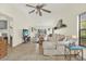 Open-concept living room with tile flooring, comfortable seating, and view into the dining area at 11419 Donneymoor Dr, Riverview, FL 33569