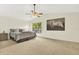 Spacious main bedroom featuring a ceiling fan and large window with natural light at 11419 Donneymoor Dr, Riverview, FL 33569