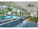 Enclosed lanai with view of pool, ceiling fans, and sitting area at 11419 Donneymoor Dr, Riverview, FL 33569