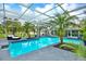 In ground pool surrounded by beautiful tropical landscaping and comfortable seating at 11419 Donneymoor Dr, Riverview, FL 33569