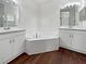 Primary bathroom featuring a large soaking tub and double sink vanity at 3328 Circleville St, North Port, FL 34286