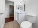 Neat bathroom features tile floors, toilet, vanity, and mirror at 3328 Circleville St, North Port, FL 34286
