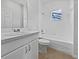 Clean bathroom featuring a tub, shower, toilet, and vanity with solid surface countertops at 3328 Circleville St, North Port, FL 34286