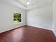 Bright bedroom with ample natural light, tray ceiling and hardwood floors at 3328 Circleville St, North Port, FL 34286