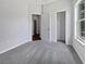 Bedroom with neutral carpet, closet, and bright window views at 3328 Circleville St, North Port, FL 34286