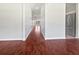 Hallway featuring hardwood flooring leading to a stainless steel refrigerator at 3328 Circleville St, North Port, FL 34286