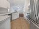 Bright kitchen features white cabinetry, modern appliances, and tile flooring throughout at 3328 Circleville St, North Port, FL 34286