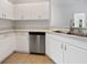 Kitchen with stainless steel appliances, white cabinets, and solid surface countertops at 3328 Circleville St, North Port, FL 34286