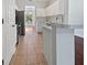 Well-lit kitchen with white cabinets, stainless steel appliances, and tile flooring at 3328 Circleville St, North Port, FL 34286