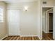 Bedroom with wood flooring, closet and open door shows depth and neutral color palette at 1722 Darlington Dr, Tampa, FL 33619