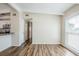 Open living area with wood-look floors and great natural light; view to kitchen and hallway at 1722 Darlington Dr, Tampa, FL 33619