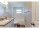 Updated bathroom with granite countertops and a tiled shower, providing a fresh and modern feel at 4702 E Idlewild Ave, Tampa, FL 33610