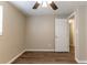 Light-filled bedroom with wood-look flooring, complemented by a ceiling fan, and a doorway to adjacent rooms at 4702 E Idlewild Ave, Tampa, FL 33610
