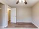 Inviting bedroom with wood-look flooring and a ceiling fan, ensuring a relaxing and welcoming retreat at 4702 E Idlewild Ave, Tampa, FL 33610