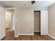 Bright bedroom featuring wood-look flooring and closet space, offering both style and practicality at 4702 E Idlewild Ave, Tampa, FL 33610