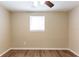 Neutral bedroom with wood-look flooring and a ceiling fan, providing a simple and inviting space at 4702 E Idlewild Ave, Tampa, FL 33610