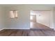 Open-concept living room featuring wood flooring and a pass-through to the kitchen at 4702 E Idlewild Ave, Tampa, FL 33610