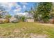 Fenced backyard with shed and view of the rear exterior at 7216 E Emma St, Tampa, FL 33610