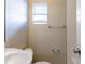 A view of a bathroom includes a toilet, sink, and fixtures in neutral colors at 7216 E Emma St, Tampa, FL 33610