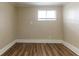 Cozy bedroom with new floors and a window providing natural light at 7216 E Emma St, Tampa, FL 33610