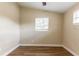Bright bedroom with wood-look flooring, neutral walls, and natural light at 7216 E Emma St, Tampa, FL 33610