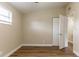 Bright bedroom with wood-look floors, natural light, and a closet at 7216 E Emma St, Tampa, FL 33610