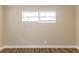 Cozy bedroom with a window letting in natural light and wood-look flooring at 7216 E Emma St, Tampa, FL 33610