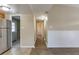 Bright hallway featuring modern lighting and access to the kitchen and other rooms at 7216 E Emma St, Tampa, FL 33610