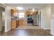 Well-lit kitchen with stainless steel appliances, wooden cabinets, and a stylish backsplash at 7216 E Emma St, Tampa, FL 33610