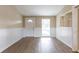Inviting living room showcasing a front door, shelving, and contemporary flooring at 7216 E Emma St, Tampa, FL 33610