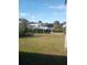 Picturesque waterfront backyard featuring a boat lift for easy water access and lush green landscaping at 18686 Van Nuys Cir, Port Charlotte, FL 33948