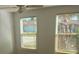 Bright bedroom featuring two large windows with blinds and neutral walls at 18686 Van Nuys Cir, Port Charlotte, FL 33948