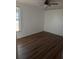 Empty bedroom featuring laminate floors, a ceiling fan and one window at 18686 Van Nuys Cir, Port Charlotte, FL 33948