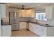 Modern kitchen featuring stainless steel appliances, white cabinetry and granite counters at 18686 Van Nuys Cir, Port Charlotte, FL 33948
