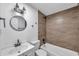 Bathroom featuring modern vanity, toilet, tub, and shower with wood-look tile at 2353 Shelley St # 3, Clearwater, FL 33765