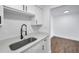 Kitchen sink with quartz countertops and stainless faucet, next to an adjacent room at 2353 Shelley St # 3, Clearwater, FL 33765