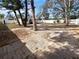 Brick backyard with a white fence and surrounding trees, providing shade at 913 27Th E St, Bradenton, FL 34208