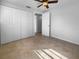 Bright bedroom with ample closet space, tile floors and ceiling fan at 913 27Th E St, Bradenton, FL 34208