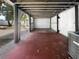Open carport area featuring a mix of concrete and brick flooring, leading to the backyard at 913 27Th E St, Bradenton, FL 34208