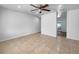 Bright living room features neutral decor, tile flooring and ceiling fan at 913 27Th E St, Bradenton, FL 34208