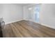 Light filled living area with wood look flooring, white walls, and glass paneled exterior door at 913 27Th E St, Bradenton, FL 34208