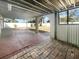 Covered outdoor patio area showcasing a brick floor with view of the fenced backyard at 913 27Th E St, Bradenton, FL 34208