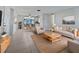 Bright living room with tile floors, tan furnishings, and an open dining area bathed in natural light at 507 Circlewood Dr # O2, Venice, FL 34293