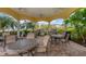 Outdoor barbecue area with multiple grills, tables, and seating under a covered pavilion at 606 Riviera Dunes Way # 604, Palmetto, FL 34221